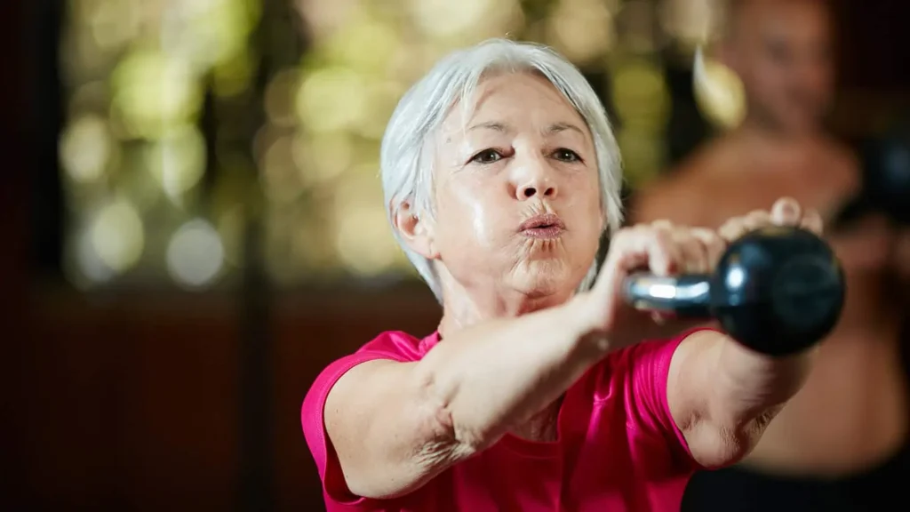 Toning Arms Without the Bulk: Is It Achievable? 1 Woman doing resistance band exercises for toned arms Bournemouth