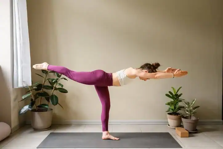 Achieving the Perfect Tone: How Often Should You Exercise for Results? 1 Woman doing Yoga exercise Bournemouth to help with toning the body.