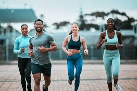 Sculpting Sleek Arms: The Essential Role of Cardio in Toning Without Bulking Up 3 image of people running to incorporate cardio Bournemouth exercise into their life to help tone arms and body.